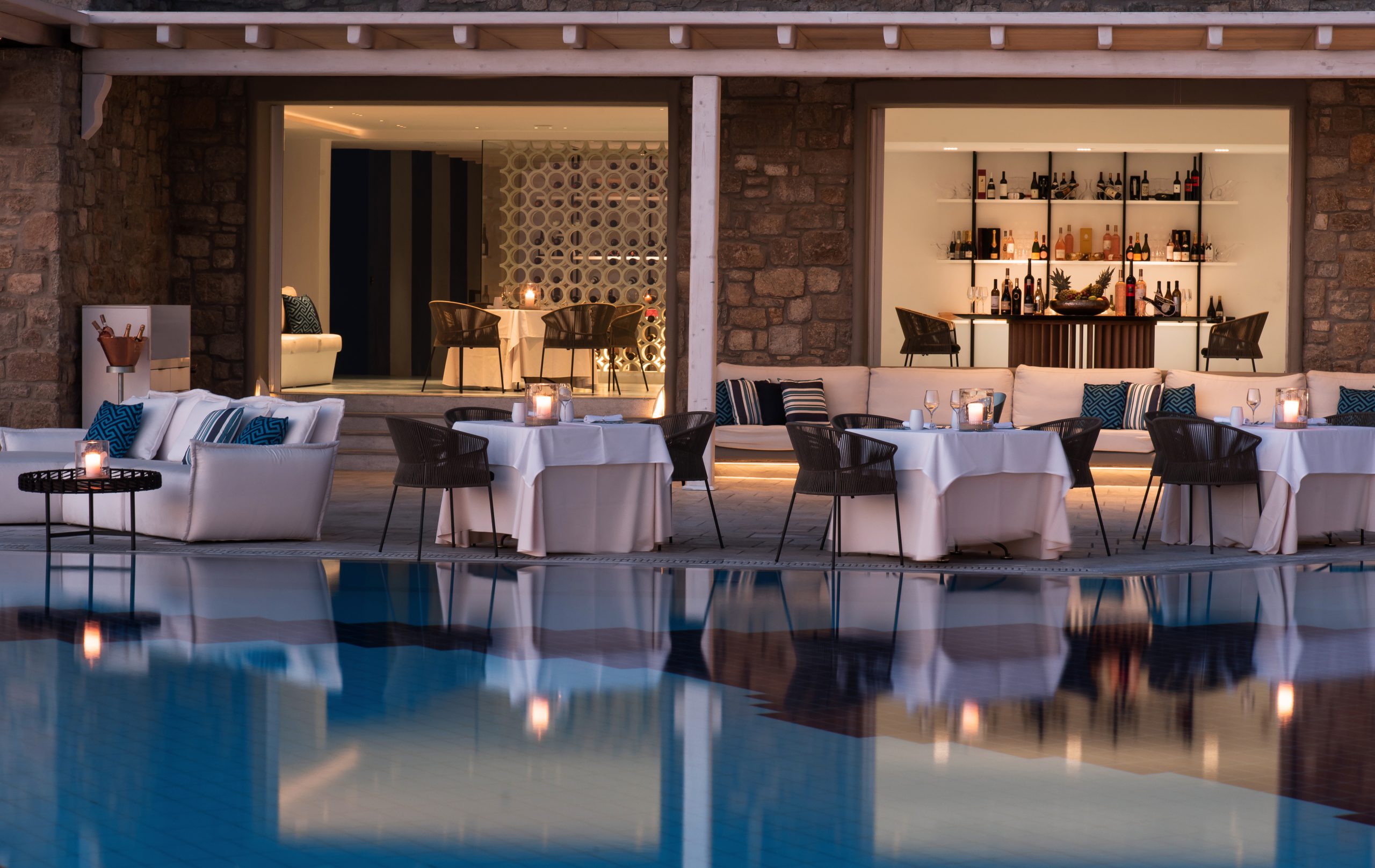A photograph of a restaurant next to a pool designed by MKV Design